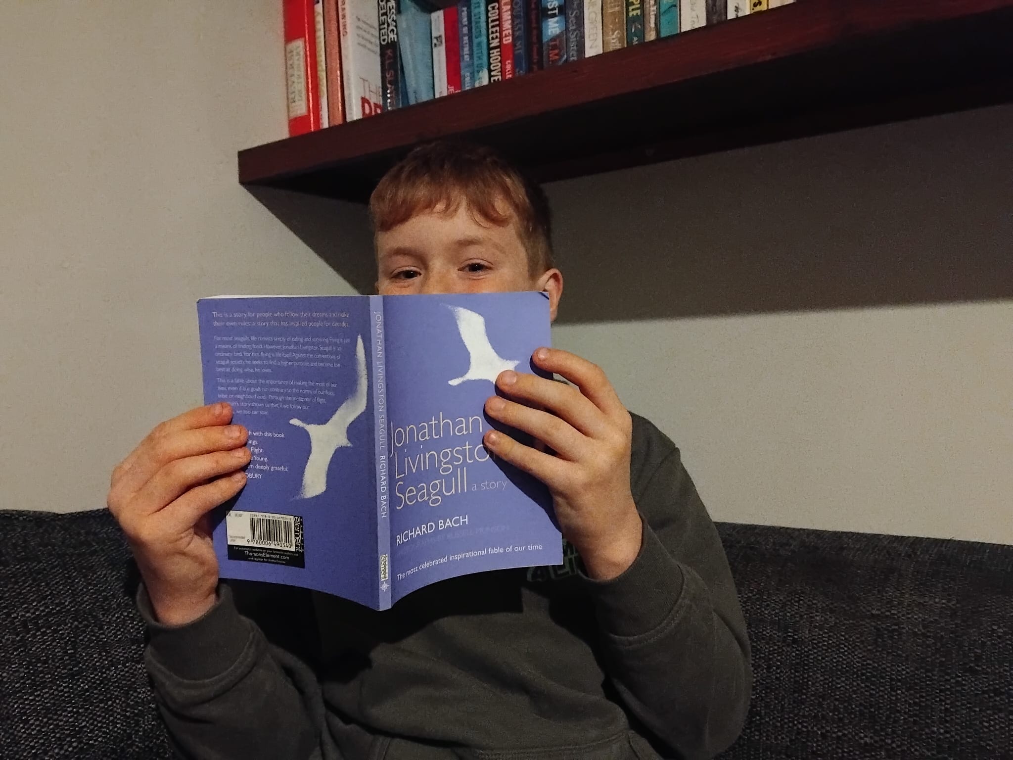 Me reading Jonathan Livingston Seagull in my father's study.